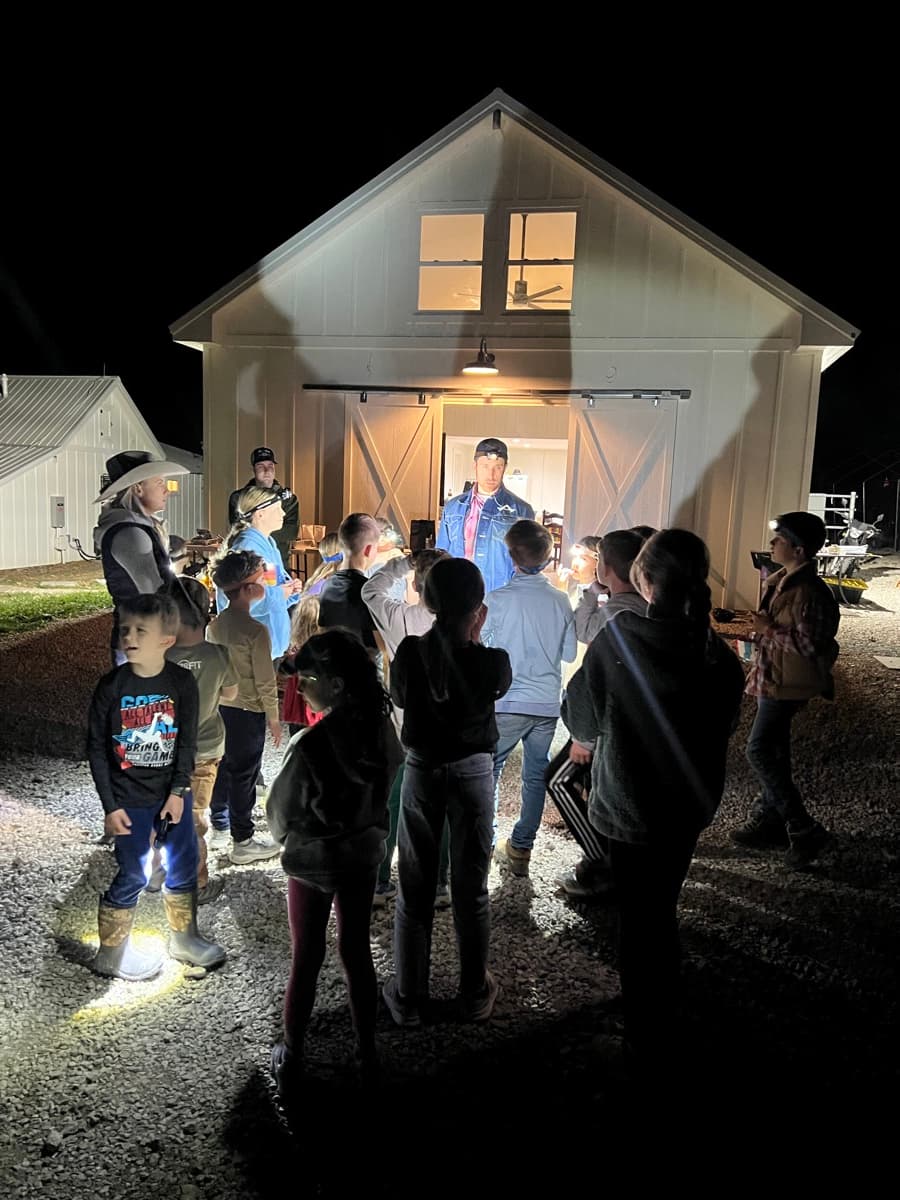 Group hanging out by the barn at night
