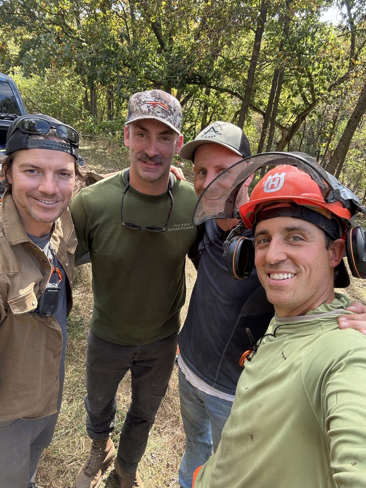 Guys in chainsaw gear after a work day
