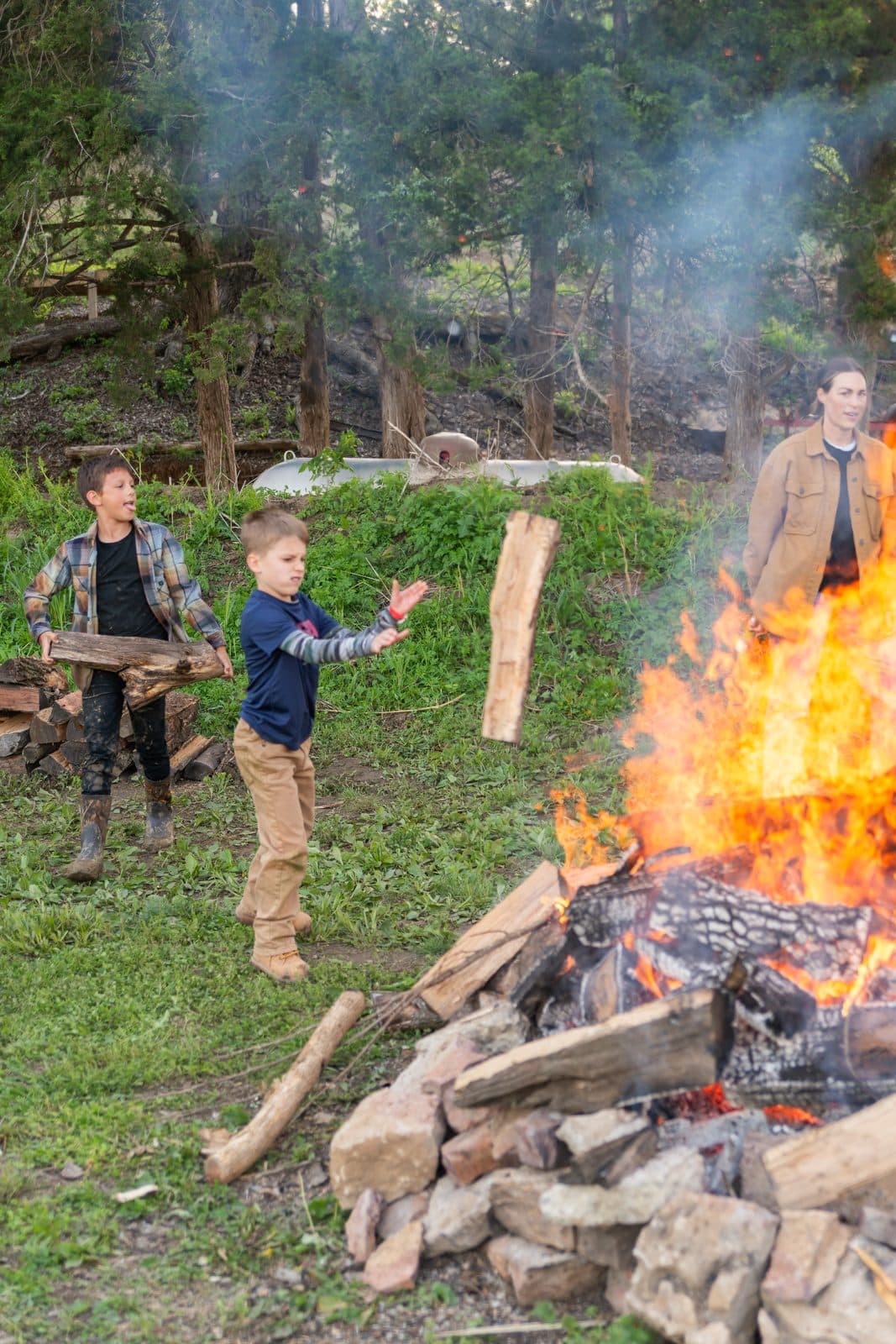 Boys throwing wood on the bonfire