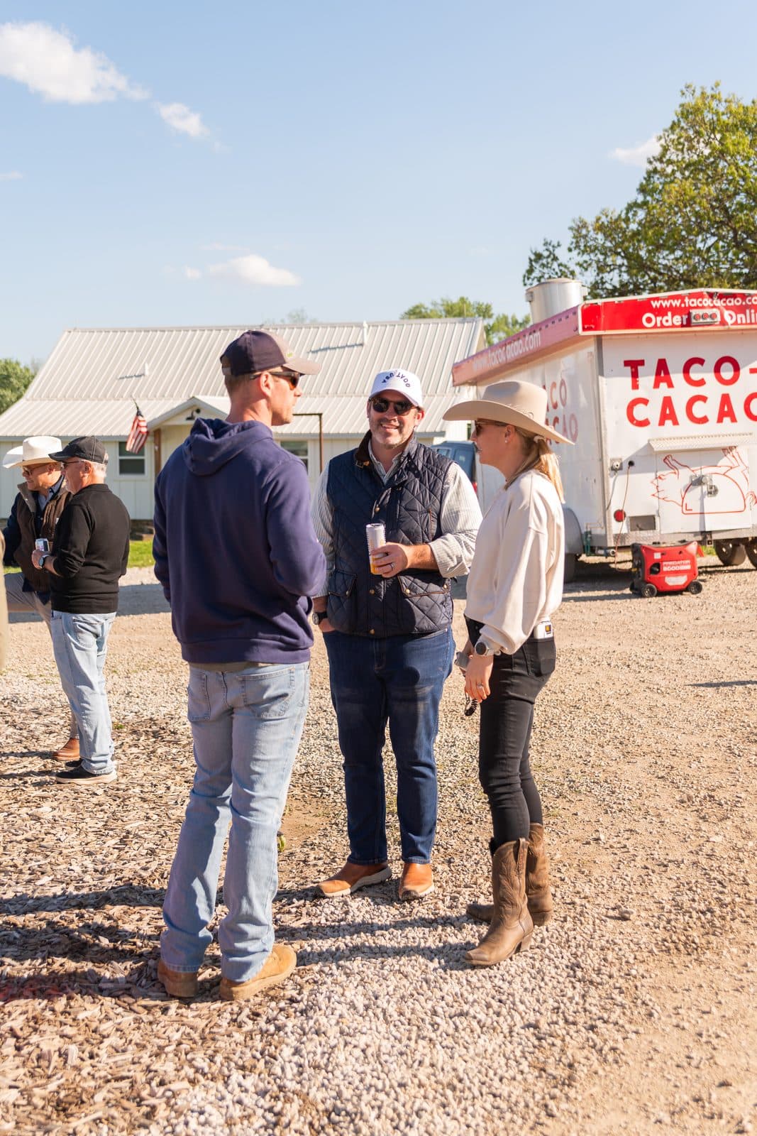 Adults chatting by the taco truck