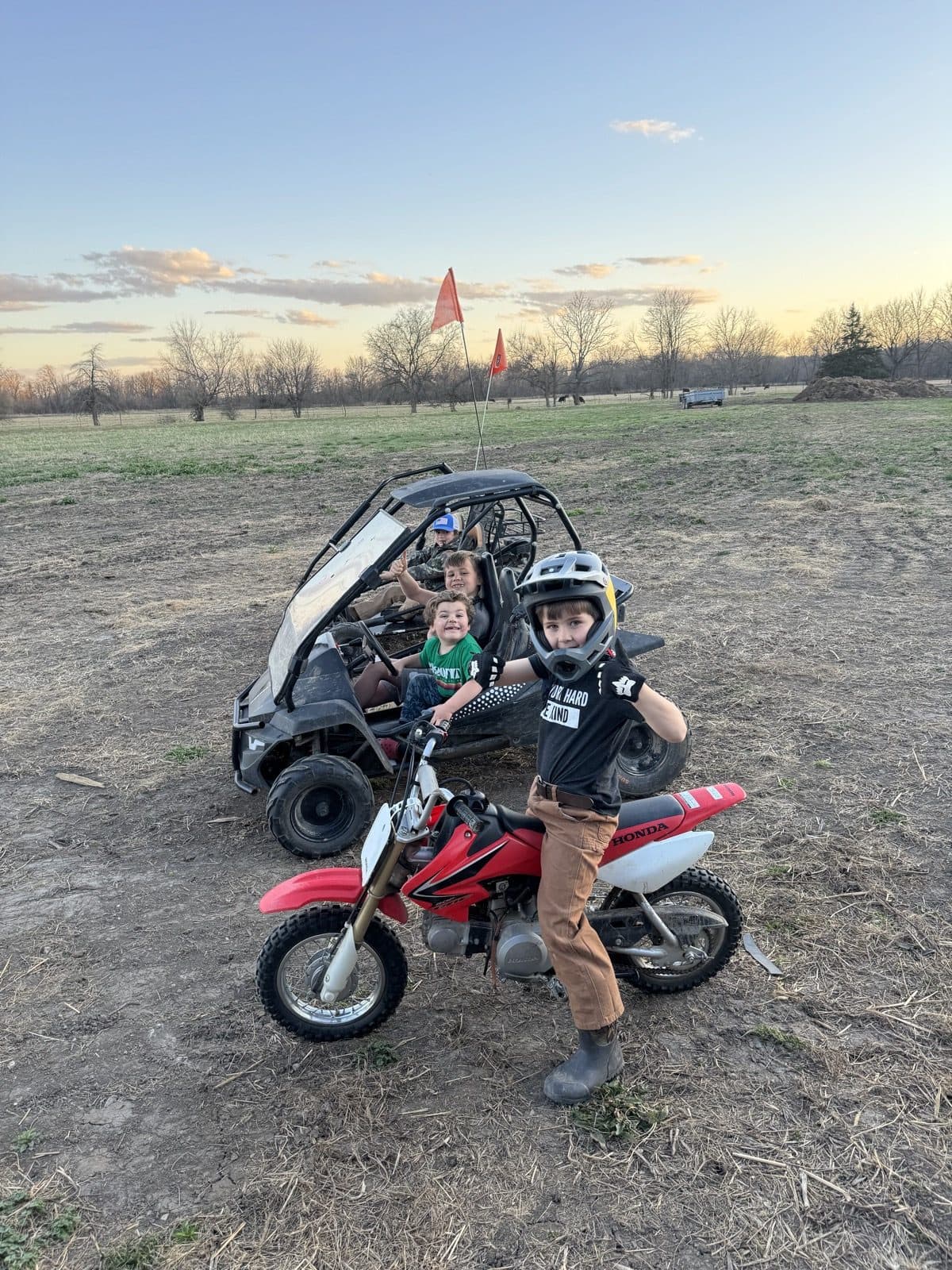Kids on dirt bikes at sunset