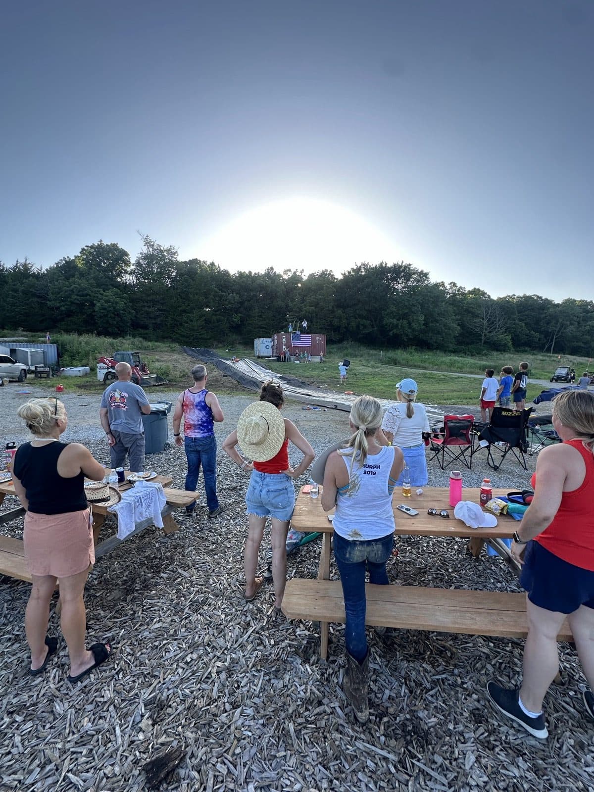 Families hanging out at the picnic tables