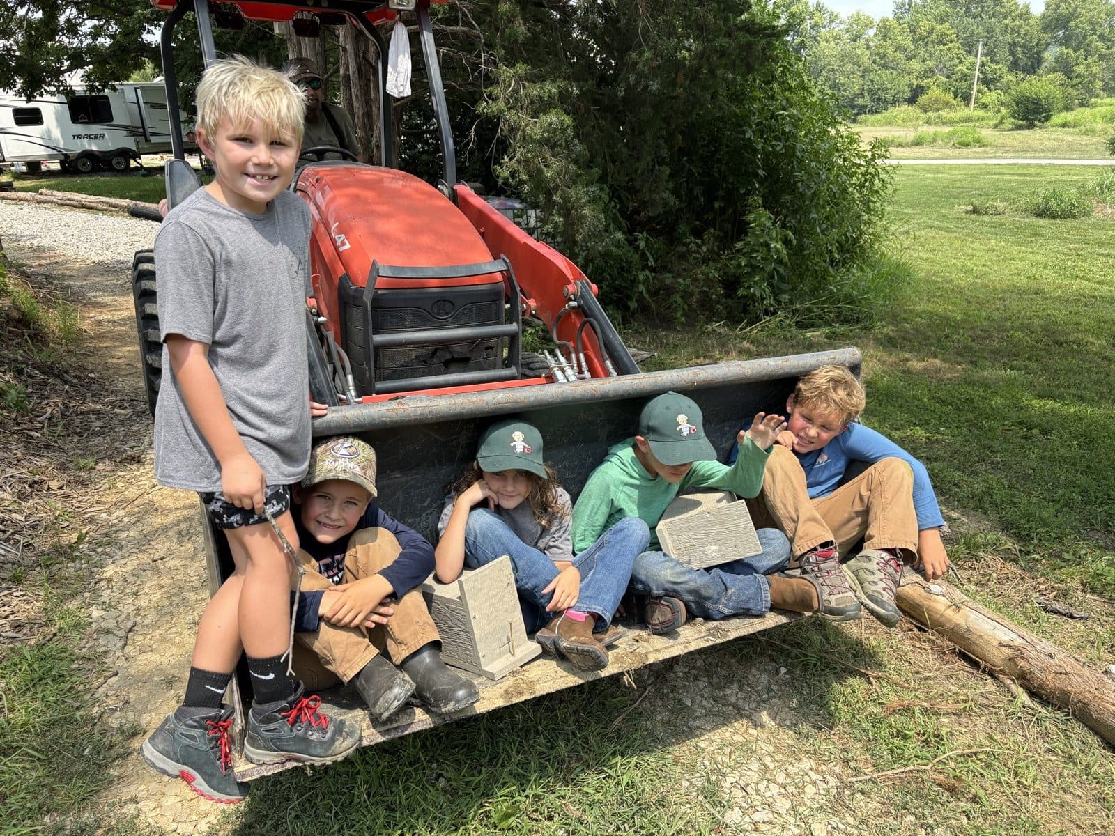 Kids sitting in the tractor bucket