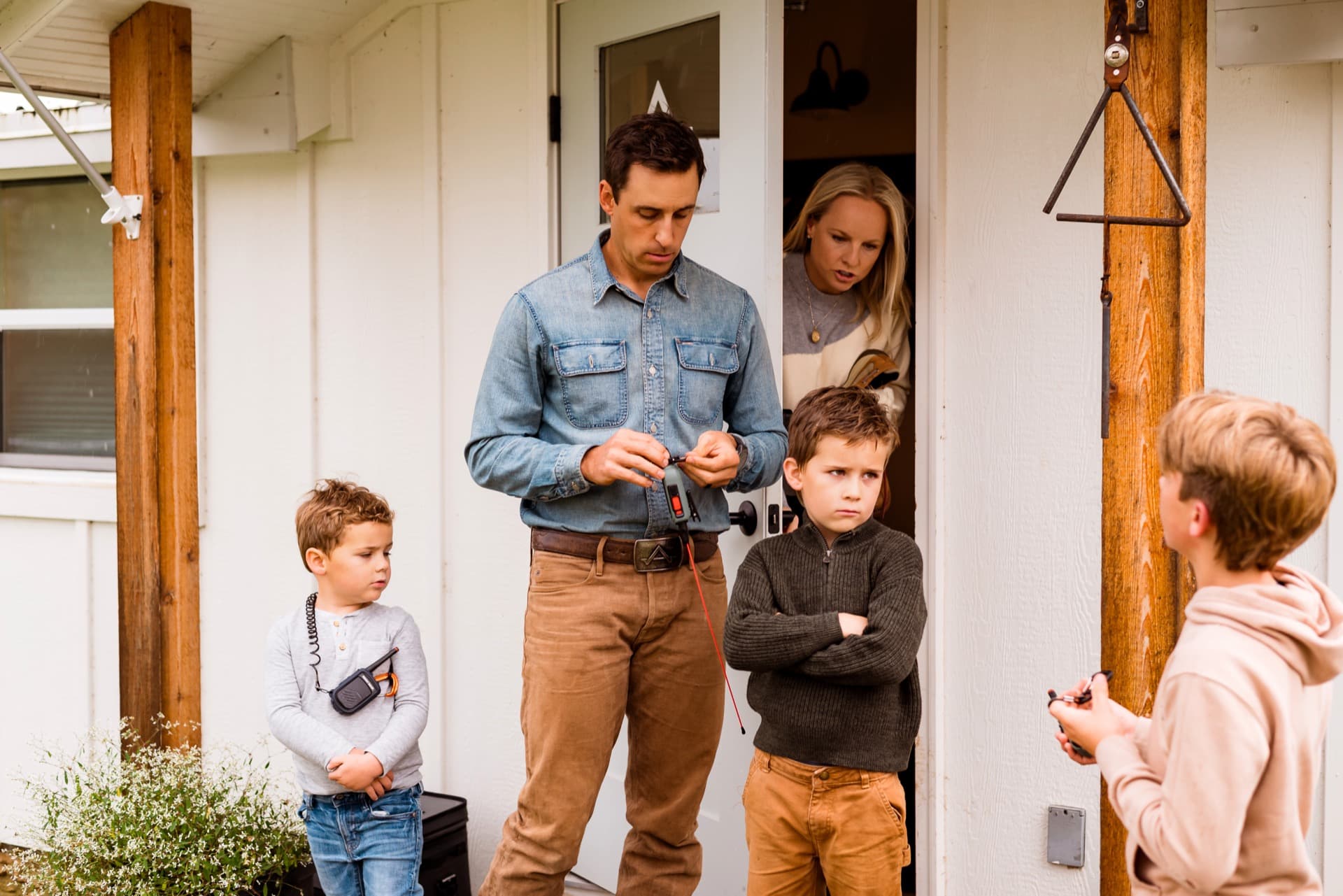 Family on the farmhouse porch ready for adventure